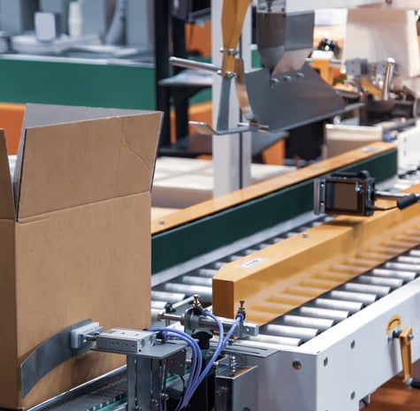 Shipping box in front of shipping rails and scanners