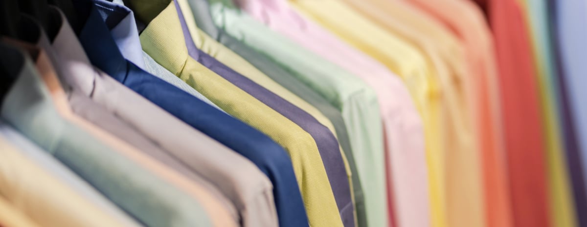 a row of hanging button-down shirts