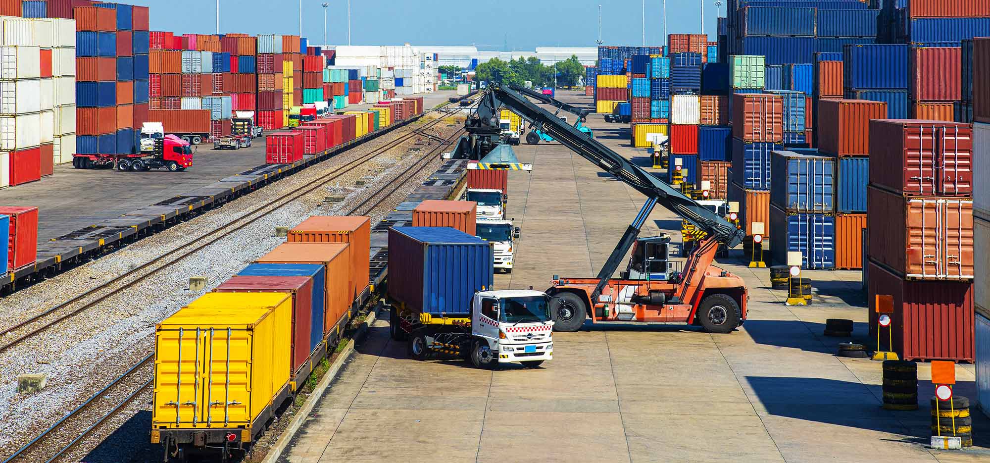 Trucks collecting and moving shipping containers