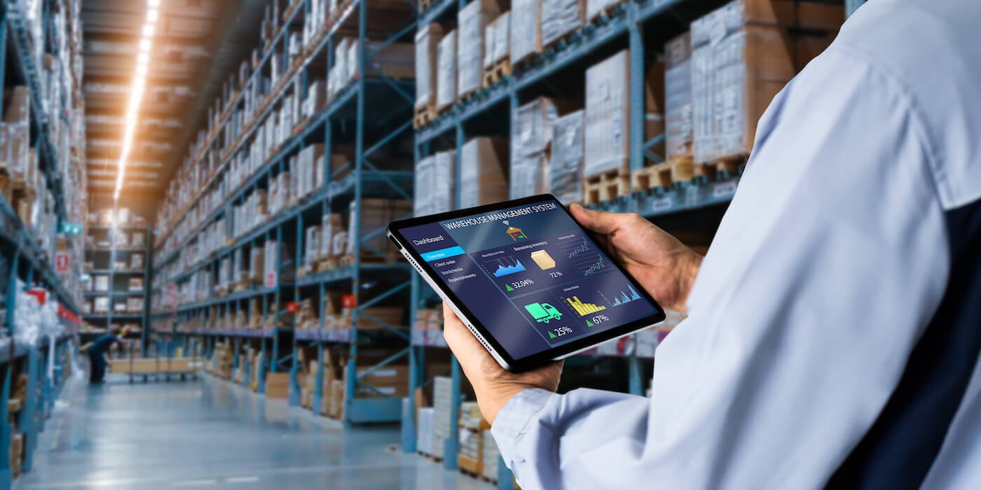supply chain warehouse management, manager using tablet with warehouse management software